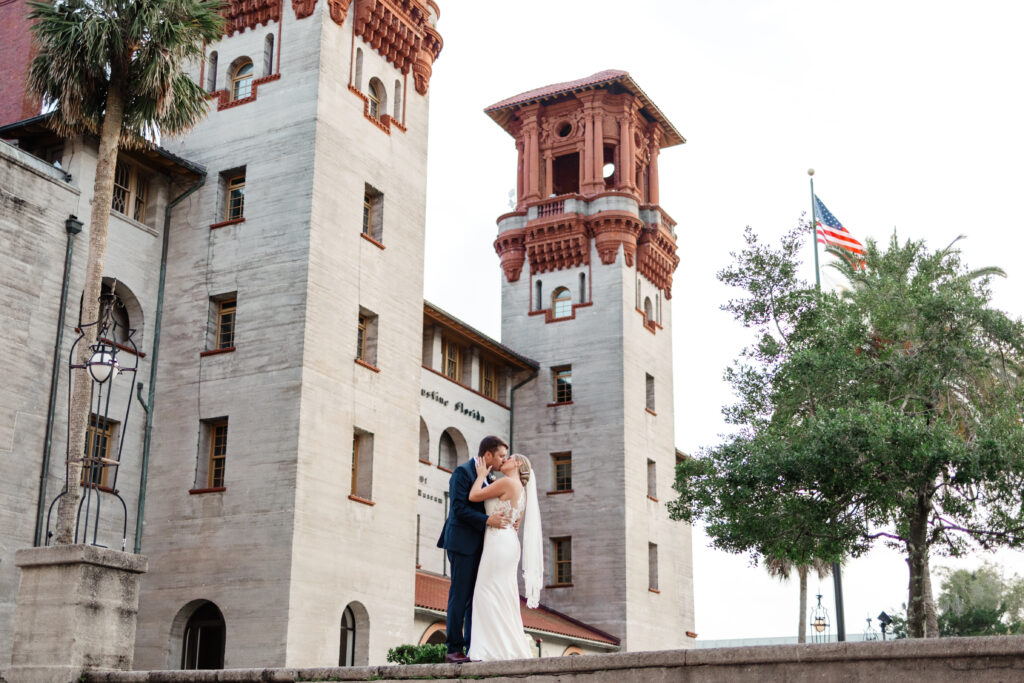 wedding bride and groom photographed in front of the lightner museum in st augustine florida